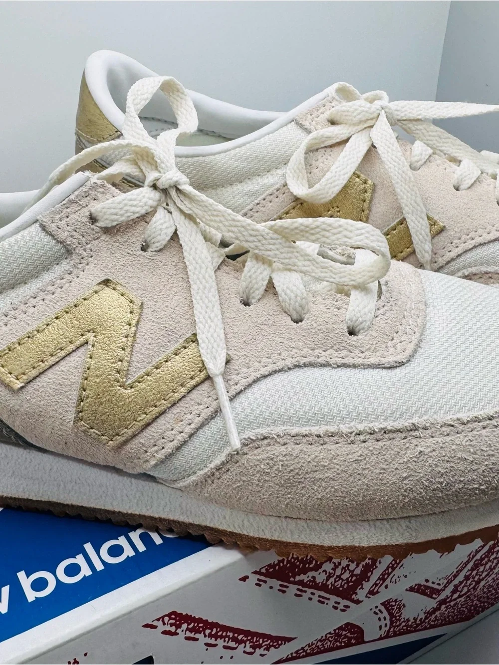 New Balance Women’s White Sneakers with Gold Accents